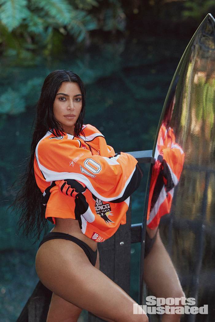Kim Kardashian was photographed by Greg Swales in the Dominican Republic. Swimsuit by SKIMS. Top by Balenciaga. Gloves by Fox.